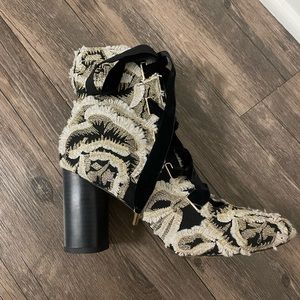 Embellished and embroidered black and gold chunky heels with velvet ties